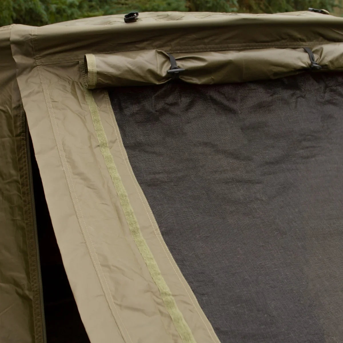 Two-man fishing bivvy in olive green with mesh window and durable fabric, designed for outdoor use and easy setup
