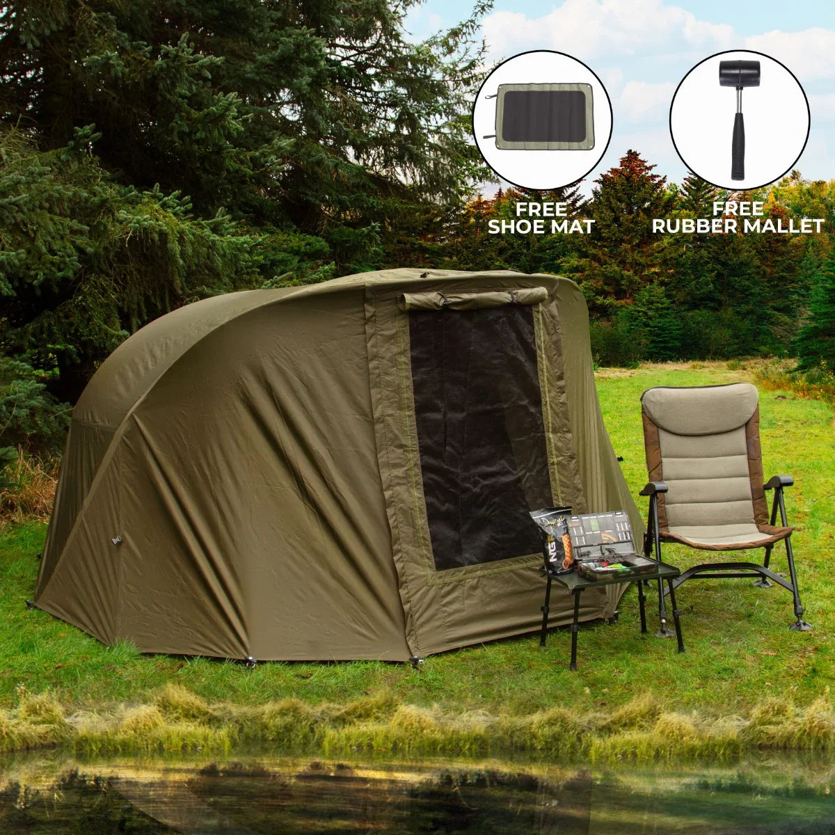 Two-man fishing bivvy in olive green, featuring a mesh door, set up by a lake with a folding chair and fishing gear nearby