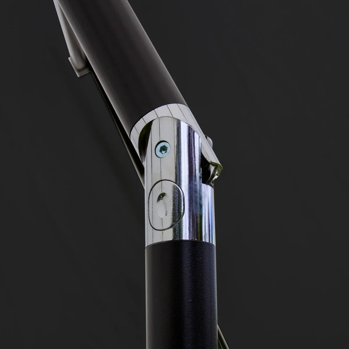 Close-up of the black metal frame and chrome connector of a 2.7m LED tilt parasol, showcasing its sturdy design and sleek finish