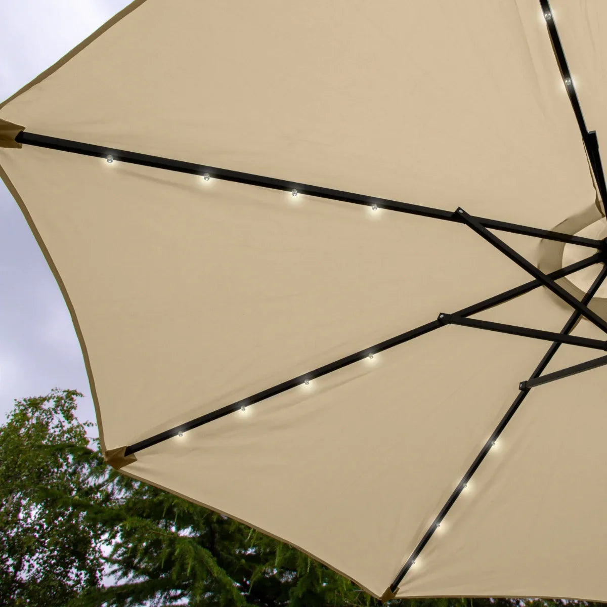 Beige 2.7m LED tilt parasol with black metal frame, illuminated edges, and a spacious canopy perfect for outdoor shading