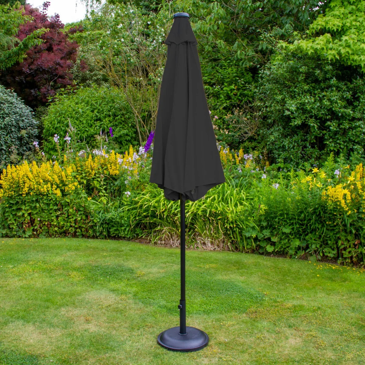 Grey 2.7m LED tilt parasol with a sleek design, sturdy black pole, and a fabric canopy, set against a vibrant garden backdrop