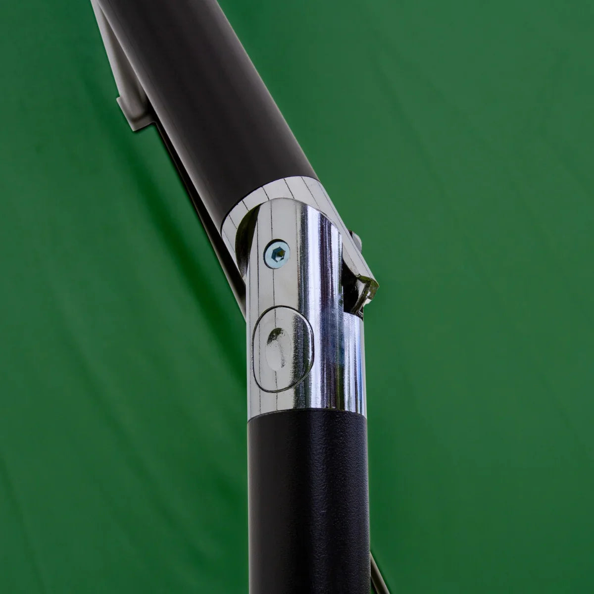 Close-up of the chrome and black pole mechanism of a green 2.7m LED tilt parasol, showcasing its sturdy design and adjustable features