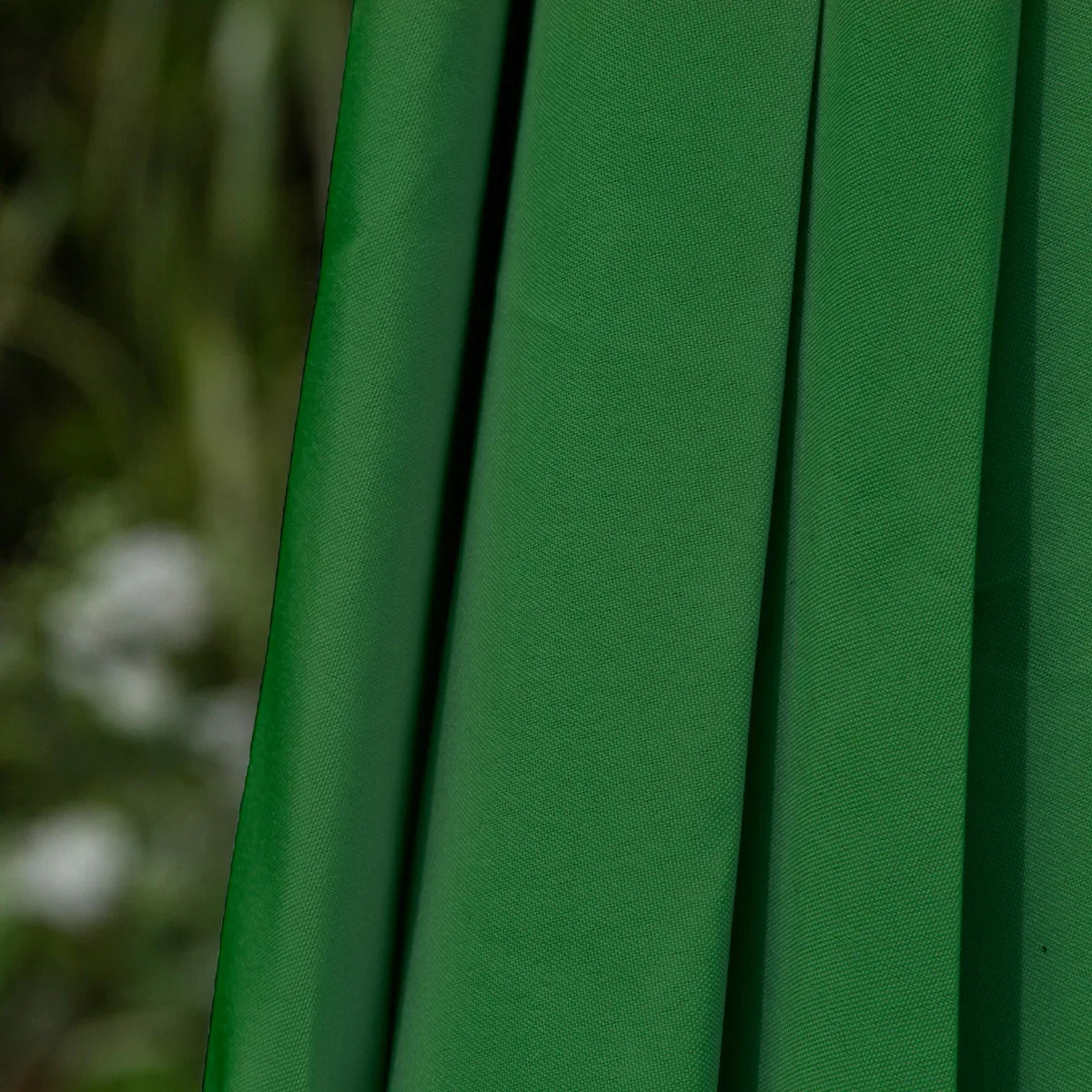 Vibrant green fabric of a 2.7m LED tilt parasol, showcasing smooth texture and elegant draping, perfect for outdoor shade