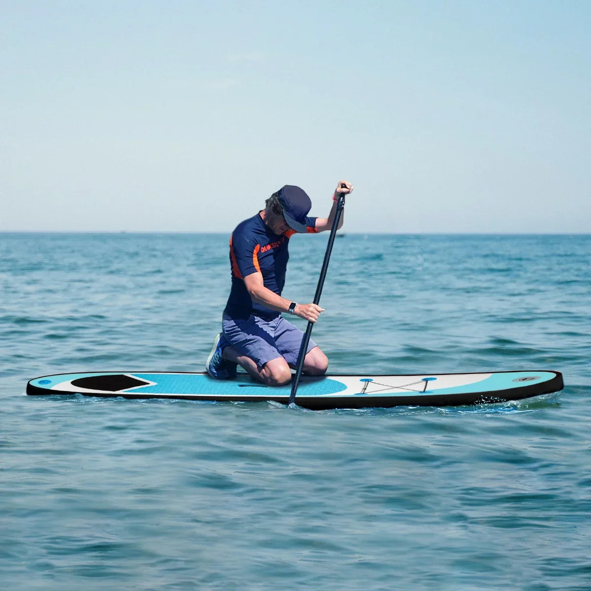 10ft blue inflatable paddle board on water, featuring a textured surface, sleek design, and a person paddling while kneeling