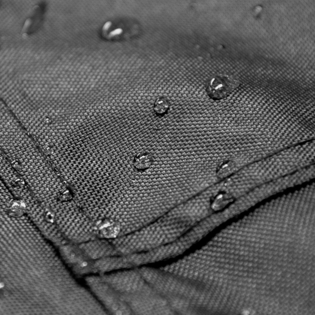 Close-up of a water-resistant black fabric with droplets, showcasing the durable texture of the large motorbike tent material