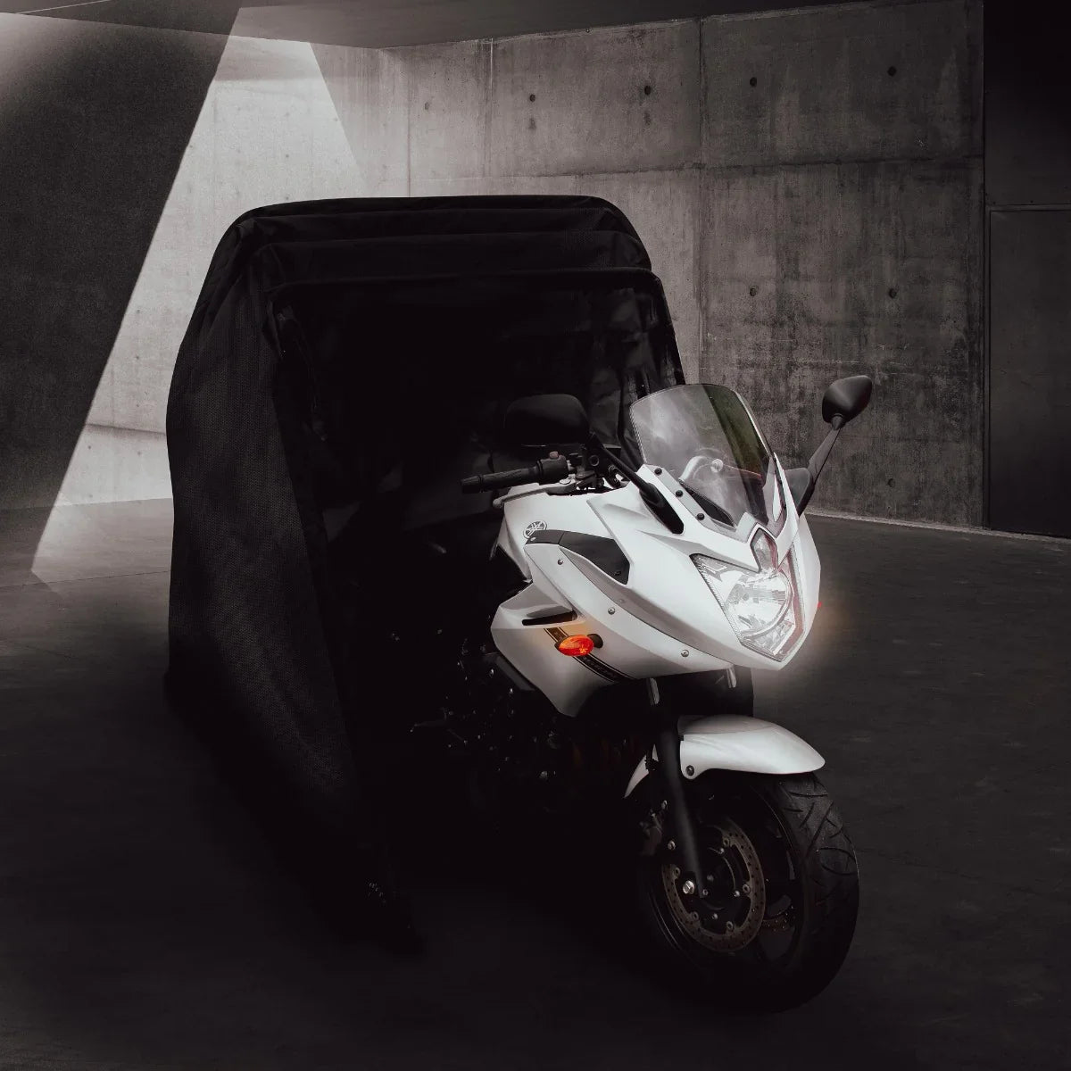 Large motorbike tent in sleek black, showcasing a white motorcycle partially covered, designed for protection and storage