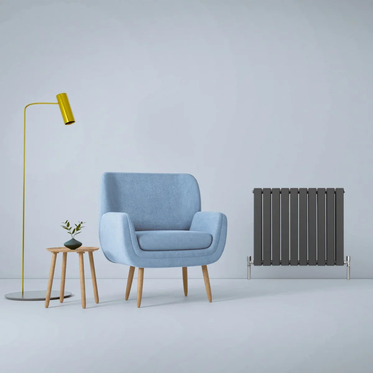 Designer flat panel radiator in anthracite grey, 600mm x 700mm, set in a modern room with a blue chair and stylish lamp