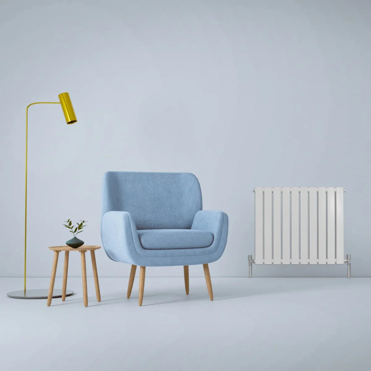 Gloss white designer flat panel radiator, 600mm x 700mm, sleek and modern design, complements a cozy blue armchair and stylish decor