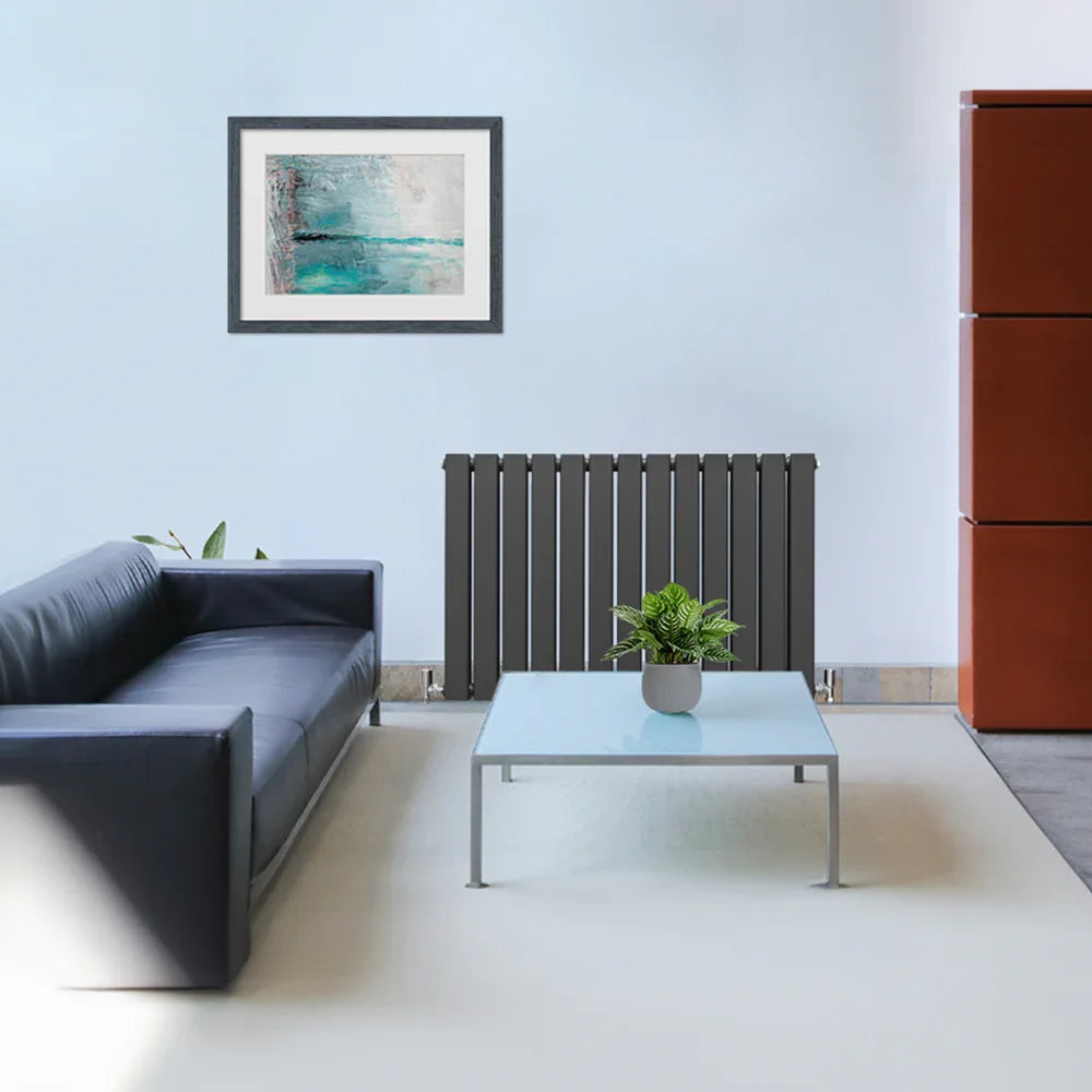 Anthracite grey designer flat panel radiator in a modern living room, featuring sleek vertical lines and a minimalist design