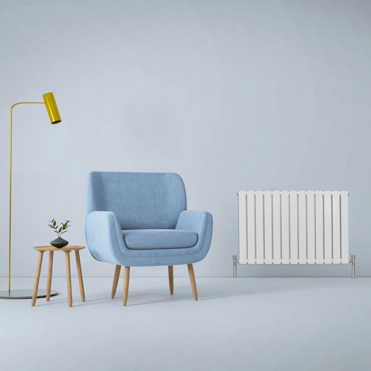 Gloss white designer flat panel radiator 600mm x 910mm beside a blue armchair and modern lamp in a minimalist room setting