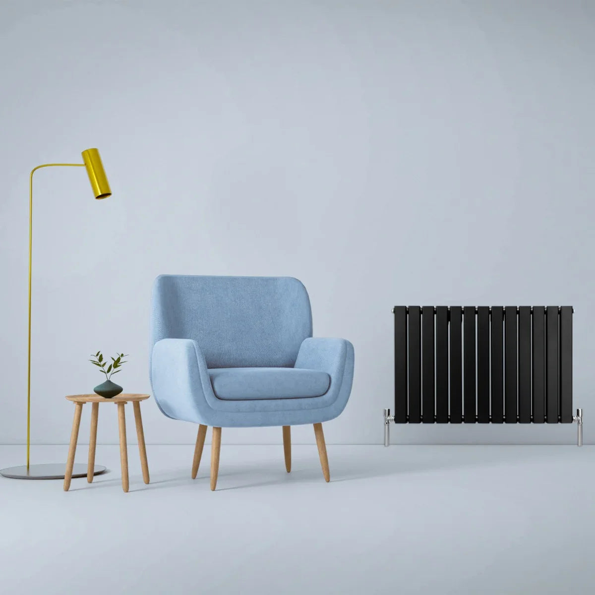 Matt black designer flat panel radiator, 600mm x 910mm, sleek vertical lines, paired with a modern blue chair and stylish decor