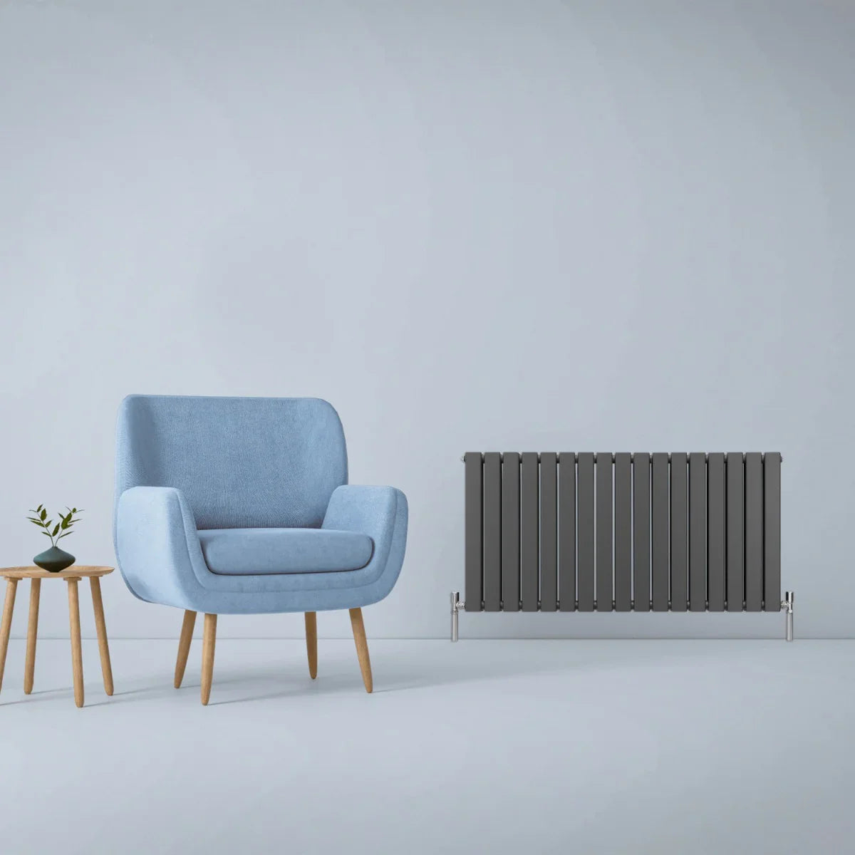 Designer anthracite grey flat panel radiator, 600mm x 1190mm, sleek vertical design with a modern finish, complementing a stylish blue chair