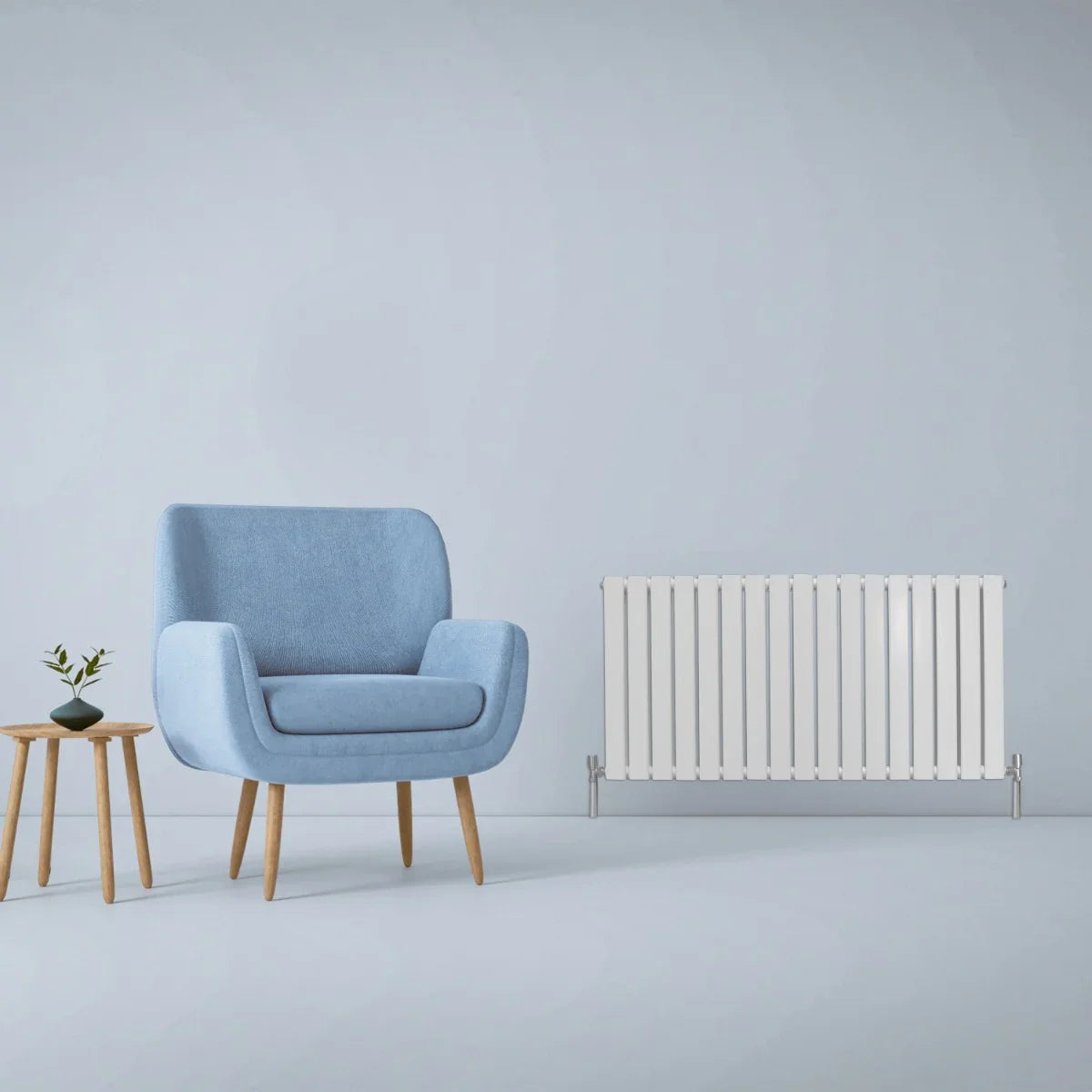 Gloss white designer flat panel radiator, 600mm x 1190mm, sleek design with vertical fins, positioned beside a blue armchair and wooden table