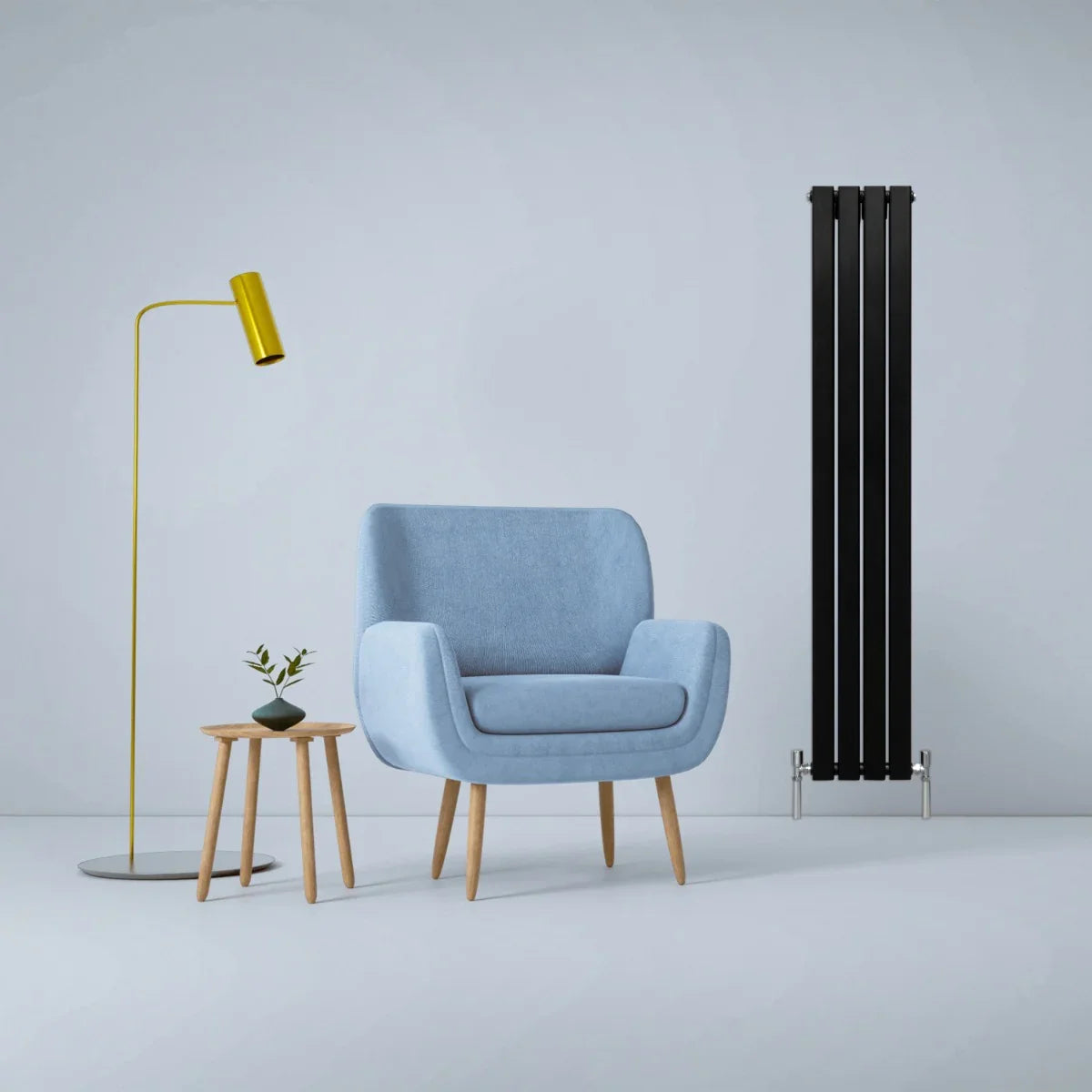 Matt black designer flat panel radiator, 1600mm x 280mm, beside a blue armchair and modern floor lamp in a stylish interior setting