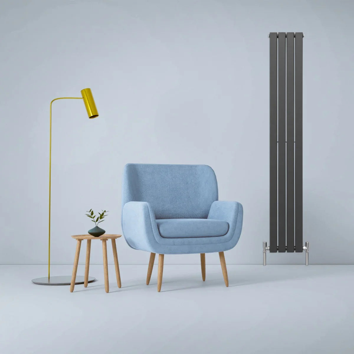 Designer flat panel radiator in anthracite grey, 1800mm x 280mm, beside a blue armchair and yellow floor lamp in a modern setting