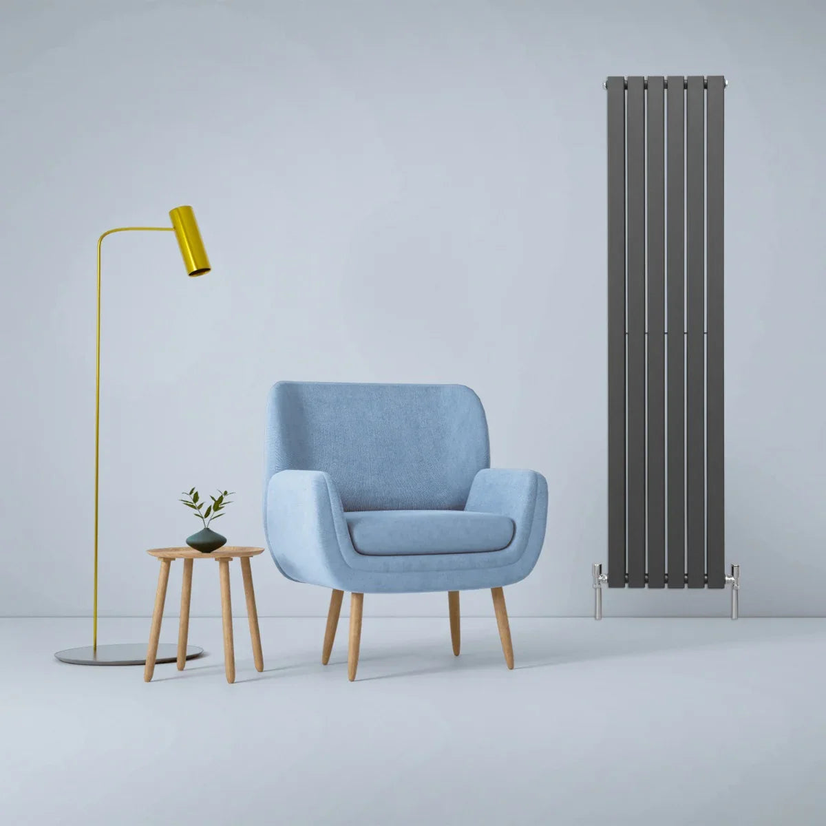 Designer flat panel radiator in anthracite grey, 1800mm x 420mm, beside a blue armchair and yellow floor lamp in a modern setting