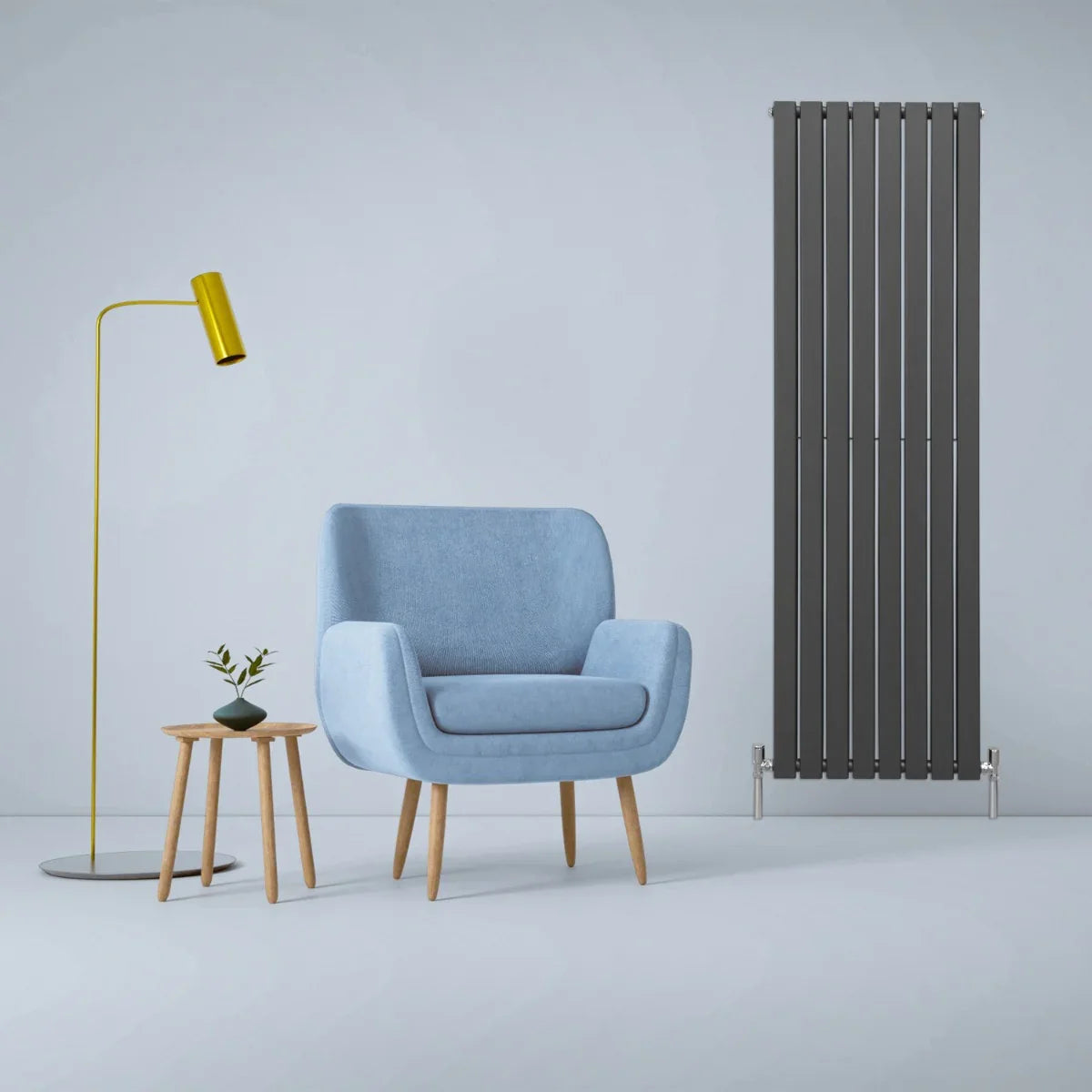 Designer flat panel radiator in anthracite grey, 1800mm x 560mm, sleek vertical design beside a blue armchair and modern lamp