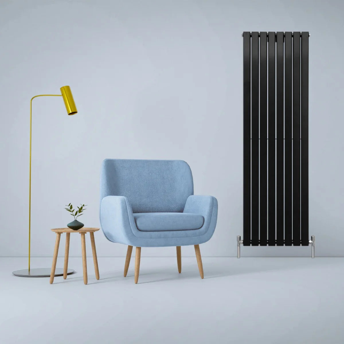 Designer flat panel radiator in matte black, 1800mm x 560mm, displayed beside a blue armchair and modern lamp in a stylish interior setting