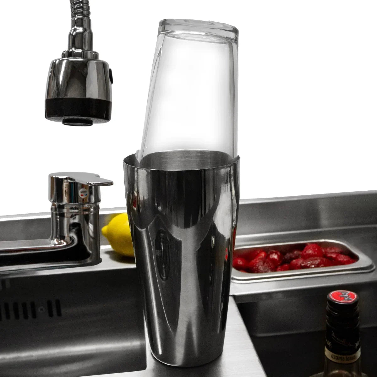 Deluxe Cocktail Bar Station features a sleek stainless steel shaker with a clear top, set against a modern bar sink with fresh fruit