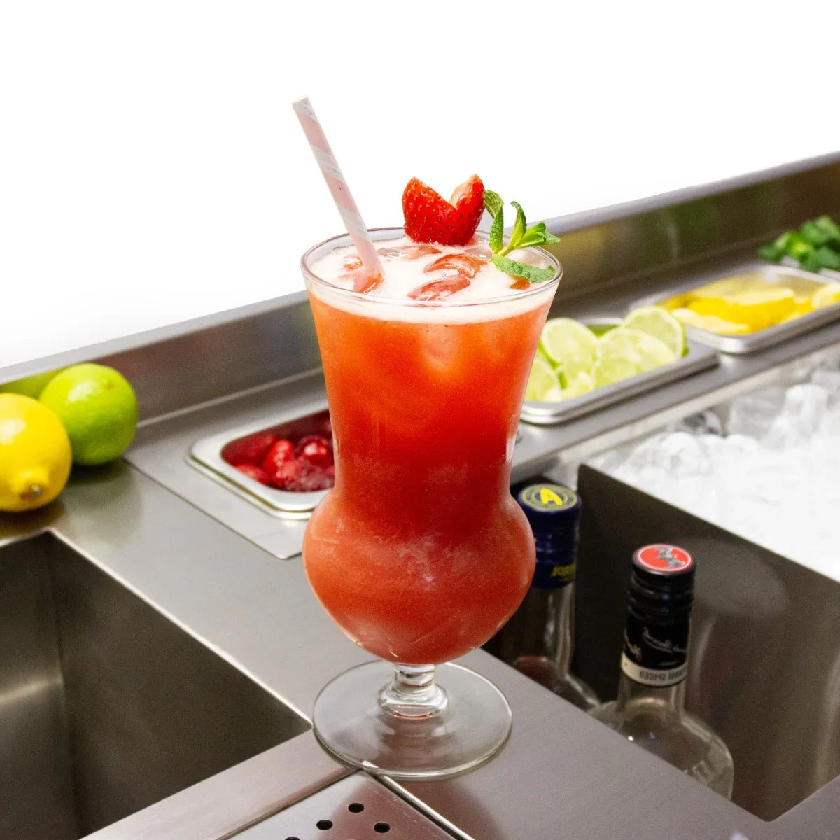 Deluxe Cocktail Bar Station featuring a vibrant red cocktail garnished with strawberries and mint, surrounded by fresh fruit and ice