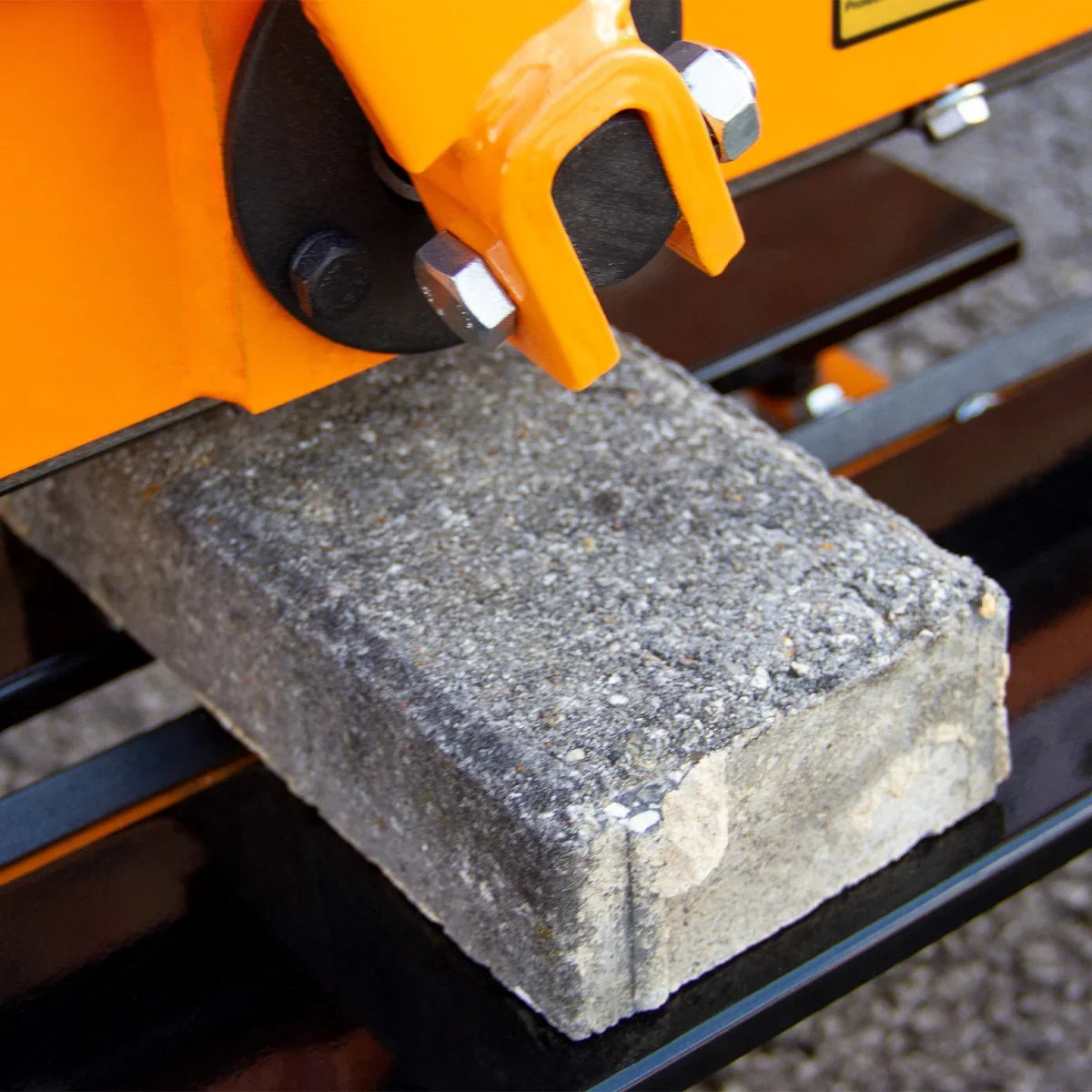 T-Mech 430mm Block Splitter with a close-up view of a concrete block positioned under the cutting blade, showcasing its robust design and precision