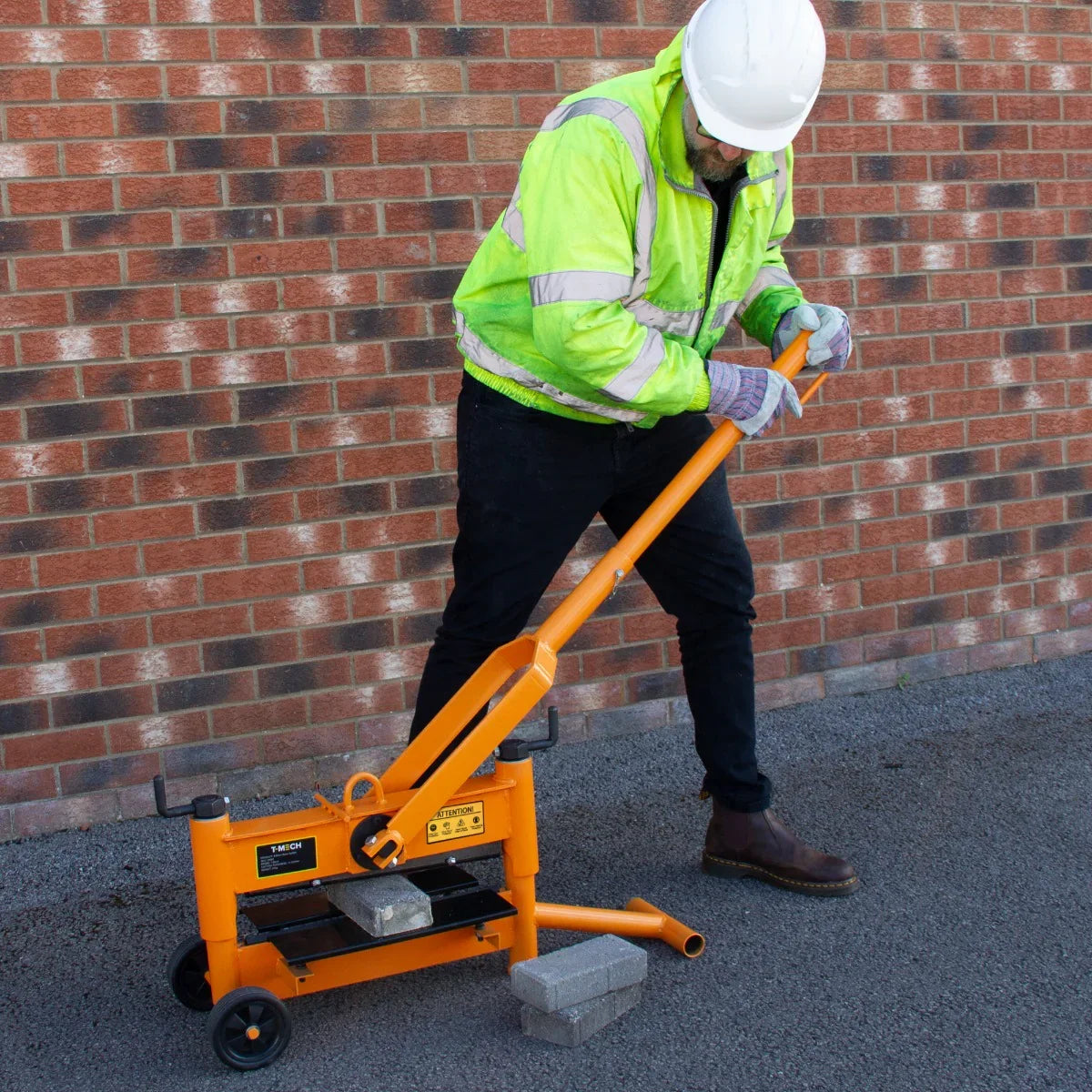T-Mech 430mm block splitter in bright orange, featuring a sturdy frame, wheeled base, and a long handle for easy operation on pavement