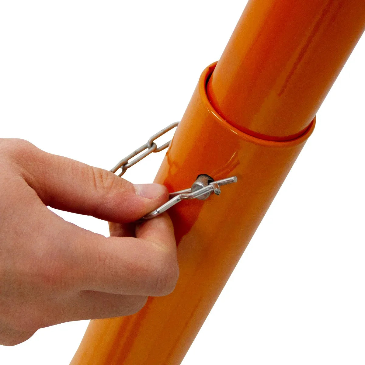 Hand securing the safety pin on the bright orange T-Mech 430mm Block Splitter, showcasing its sturdy metal construction and design features