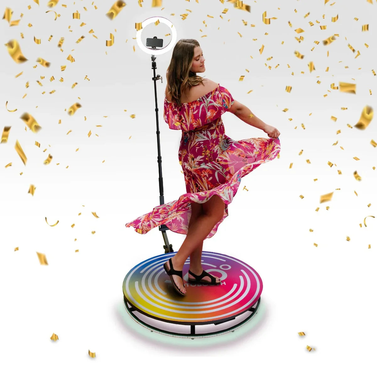 360 Photo Booth with colorful circular platform, featuring a woman in a floral dress twirling, surrounded by golden confetti