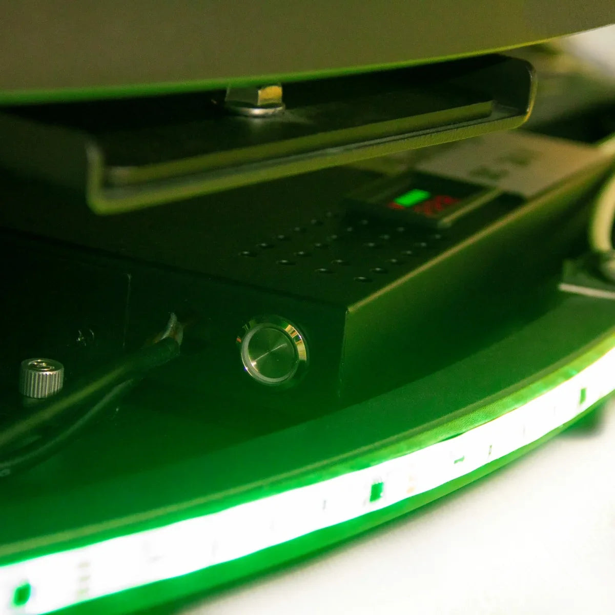 Close-up of the 360 Photo Booth's control panel, featuring a sleek black design, buttons, and green LED lighting for easy operation
