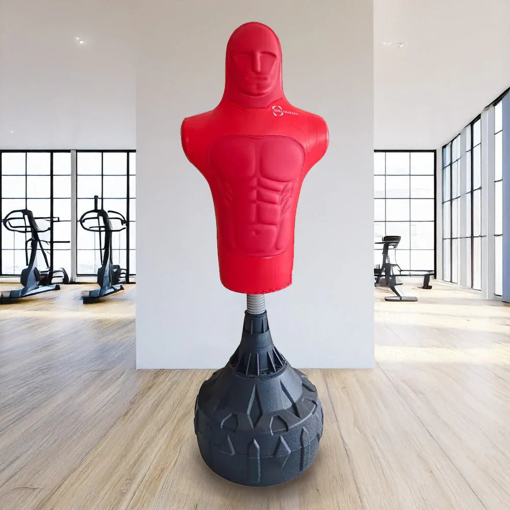 Red free-standing boxing dummy with a muscular torso design, mounted on a sturdy black base, ideal for training in a gym setting
