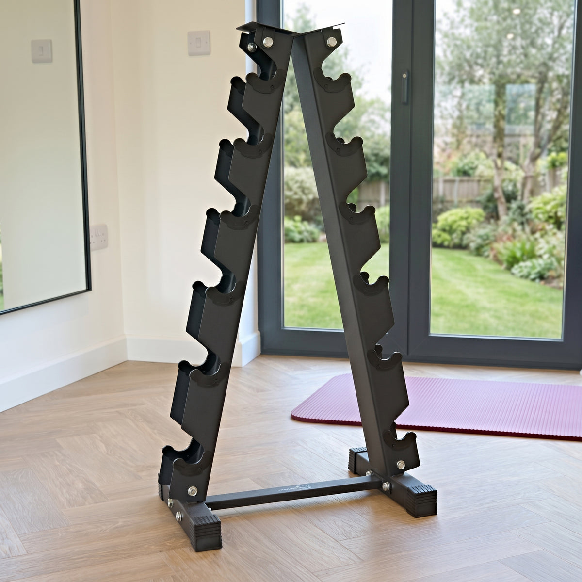 Sleek black dumbbell weight rack with six tiers, featuring a sturdy metal frame and a modern design, set in a bright home gym environment