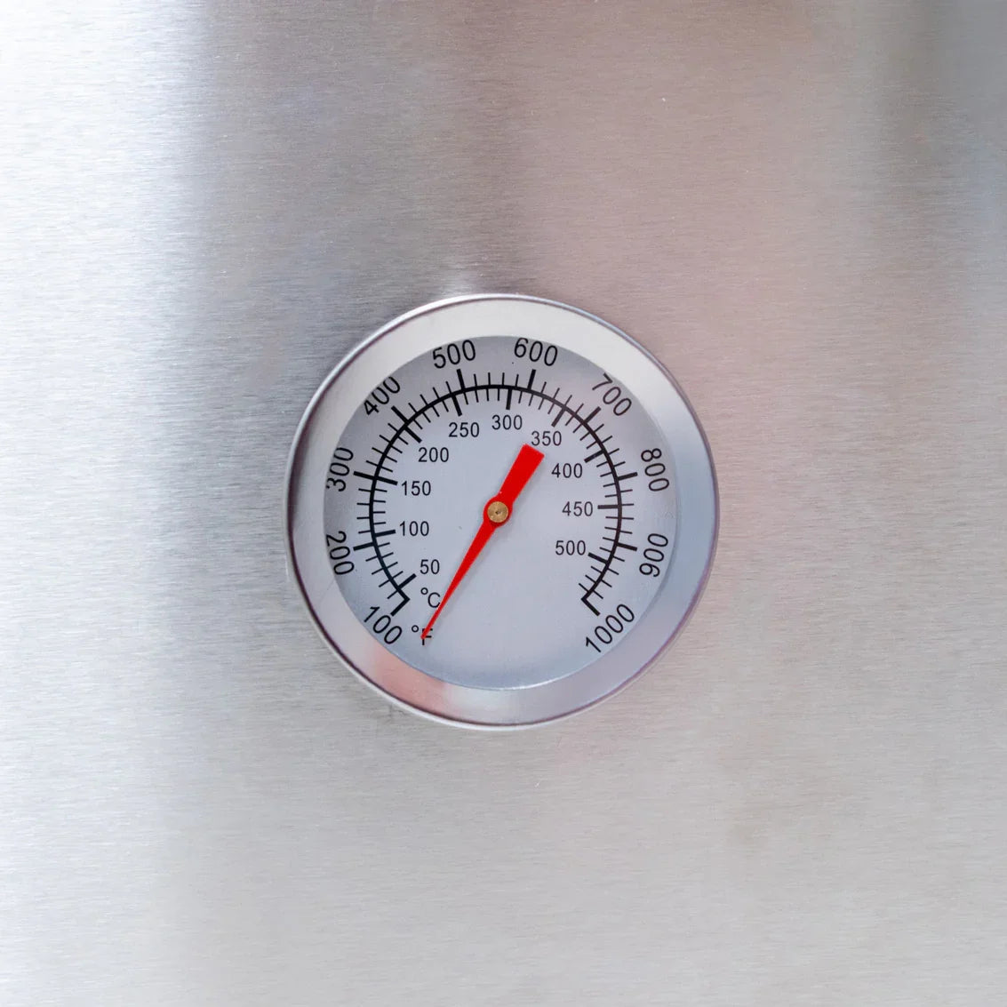 Stainless steel thermometer with a clear dial, displaying temperature readings for the Fresh Grills Premium Outdoor Pizza Oven