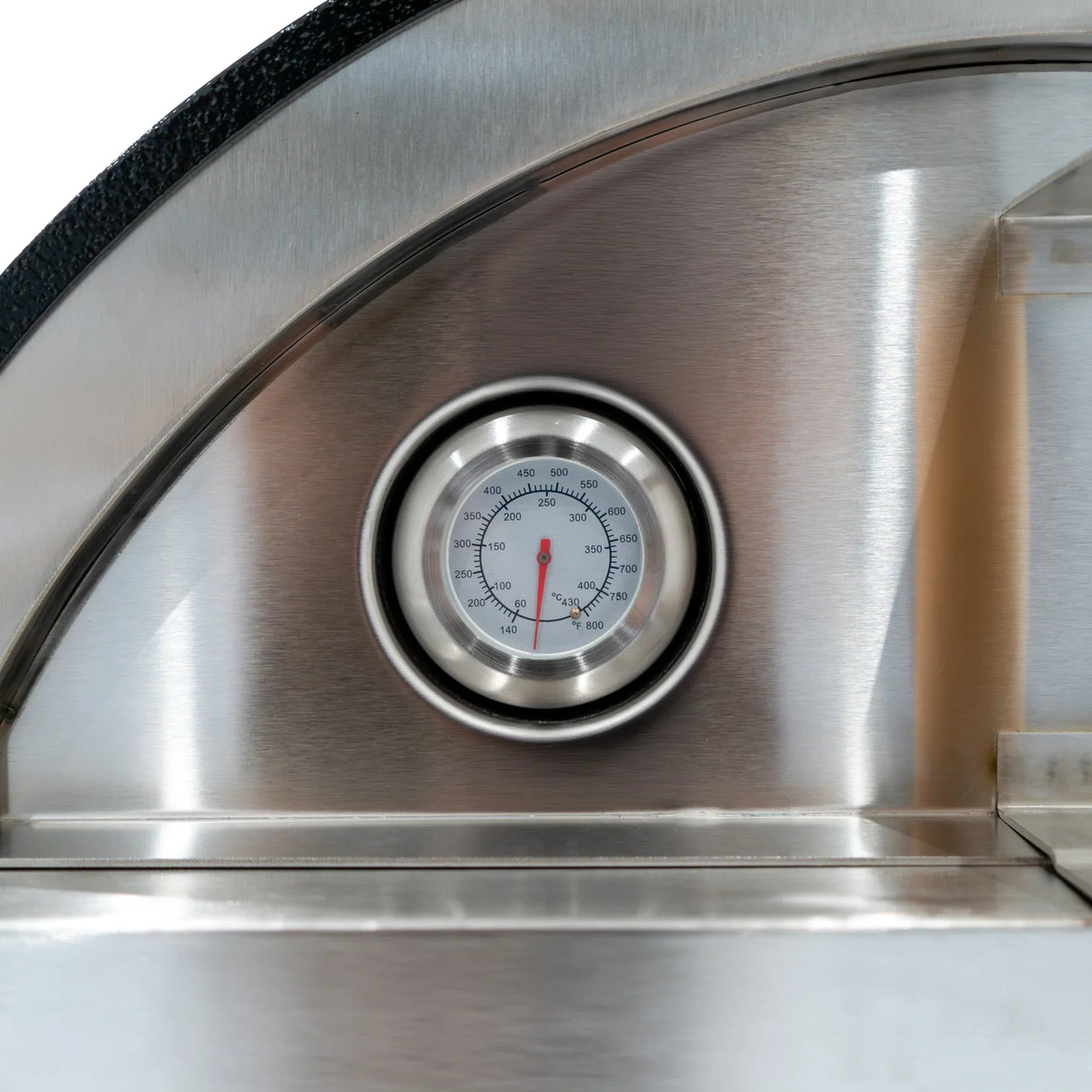 Stainless steel pizza oven with a round temperature gauge, showcasing a sleek design and durable prep station features