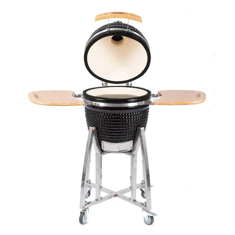 Black ceramic Kamado charcoal BBQ grill with wooden side shelves, open lid revealing a spacious cooking area and sturdy metal frame