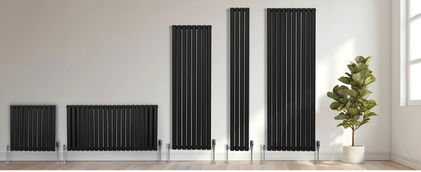 Sleek black vertical radiators in various heights against a light wall, complemented by a green potted plant on a wooden floor