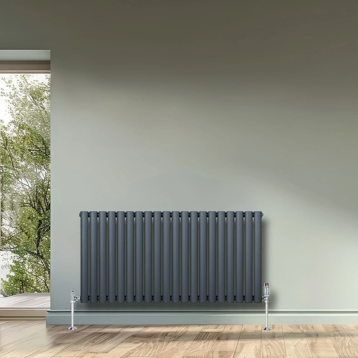Oval single column radiator in anthracite grey, 600mm x 1200mm, featuring sleek vertical lines and chrome valves, set against a neutral wall