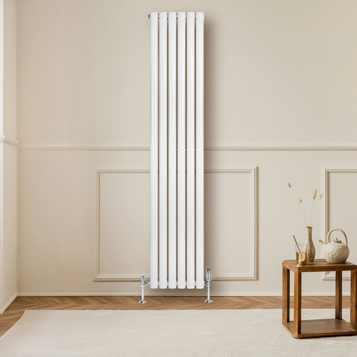 Sleek white oval single column radiator, 1800mm x 360mm, mounted on a wall, complemented by stylish valves and a cozy interior setting