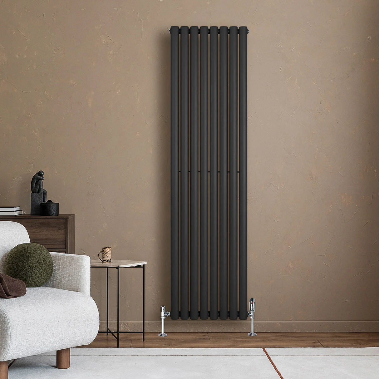 Sleek black oval single column radiator mounted on a textured wall, paired with stylish valves, enhancing modern interior decor