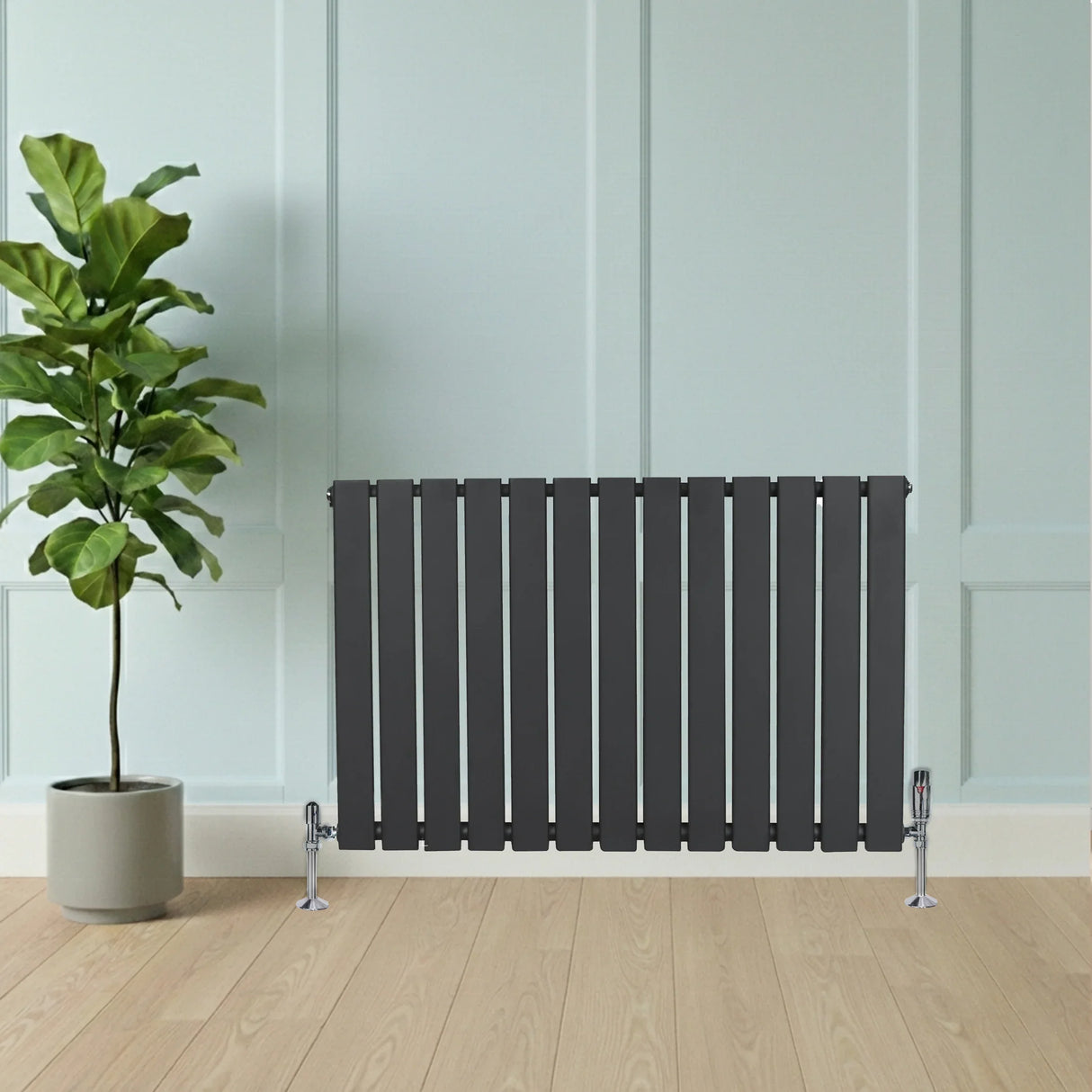 Flat single column radiator in anthracite grey, 600mm x 910mm, with sleek vertical slats and chrome valves, set against a light blue wall