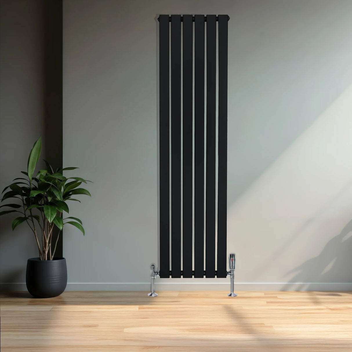 Flat black single column radiator with sleek vertical lines, paired with chrome valves, set against a minimalist interior backdrop
