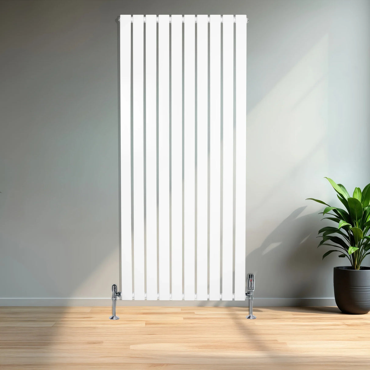 Flat single column radiator in sleek white finish, measuring 1600mm x 700mm, with chrome valves, set against a modern interior backdrop