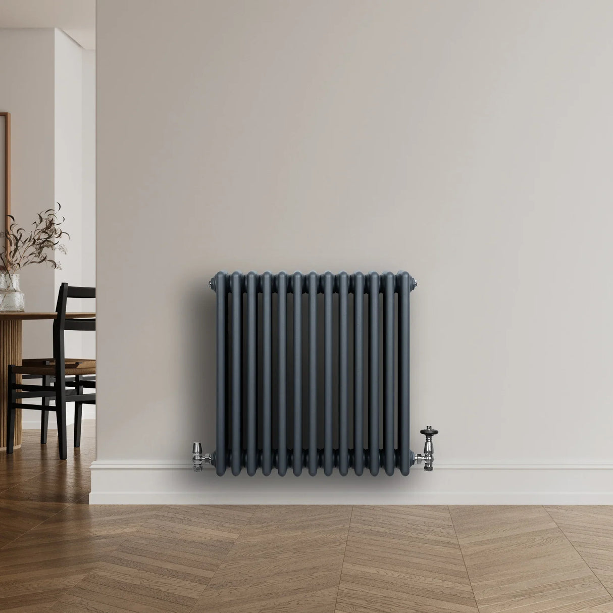 Traditional anthracite grey 4 column radiator with sleek vertical lines, mounted on a light wall, complementing modern decor