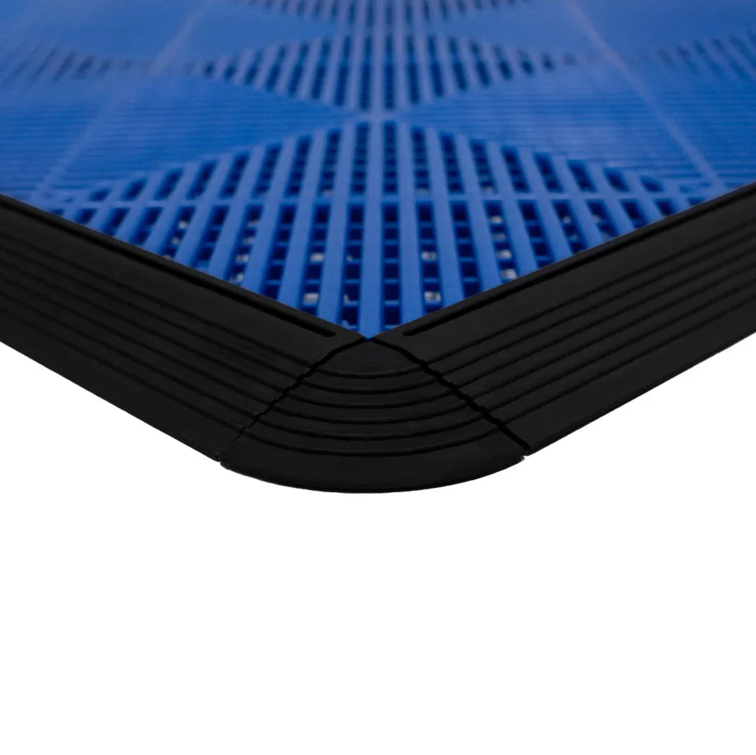 Vented garage floor tiles featuring a blue surface with a textured pattern and black edging for a secure fit and durability