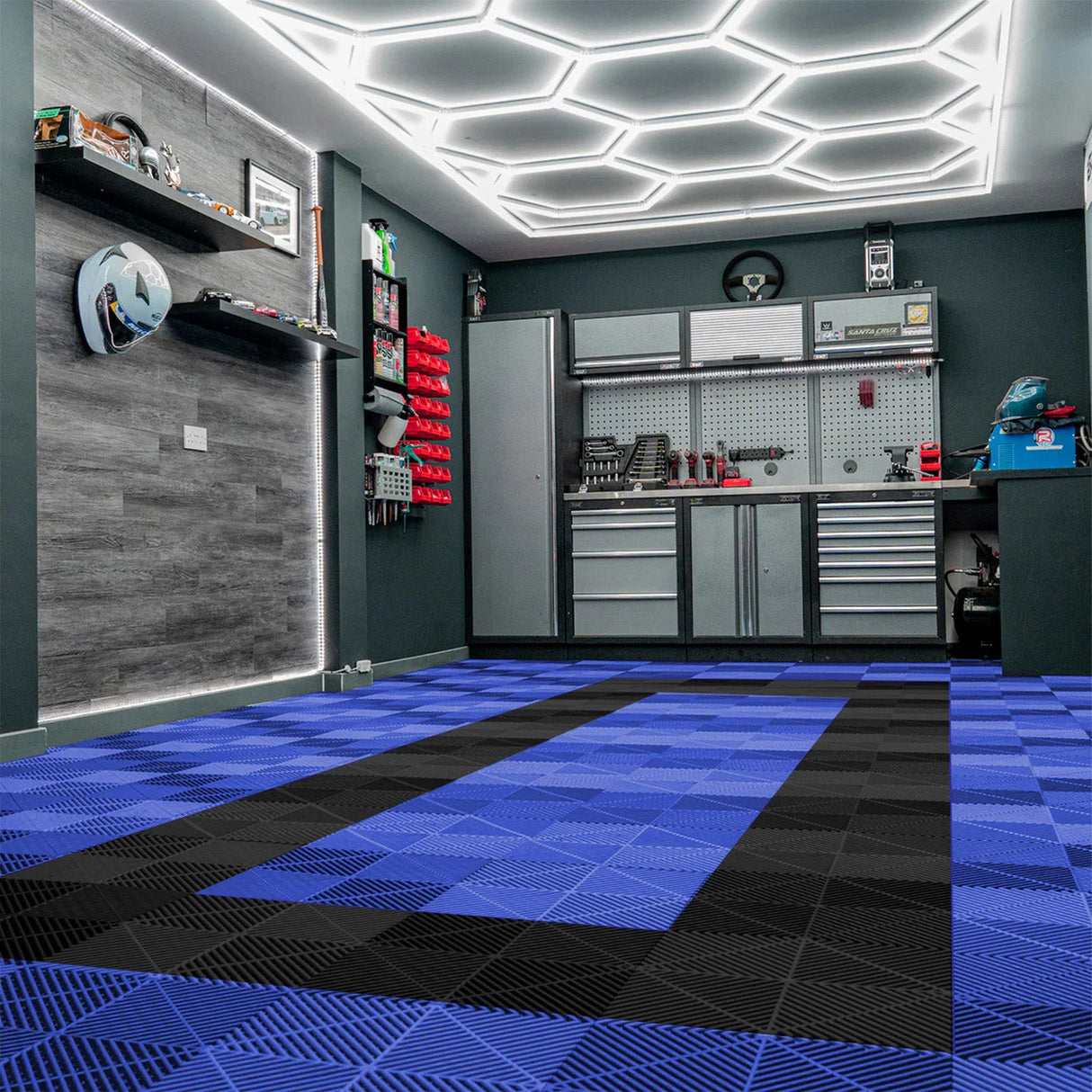 Hexagon LED light and vented garage floor tiles in blue and black, showcasing a modern garage with sleek storage and lighting