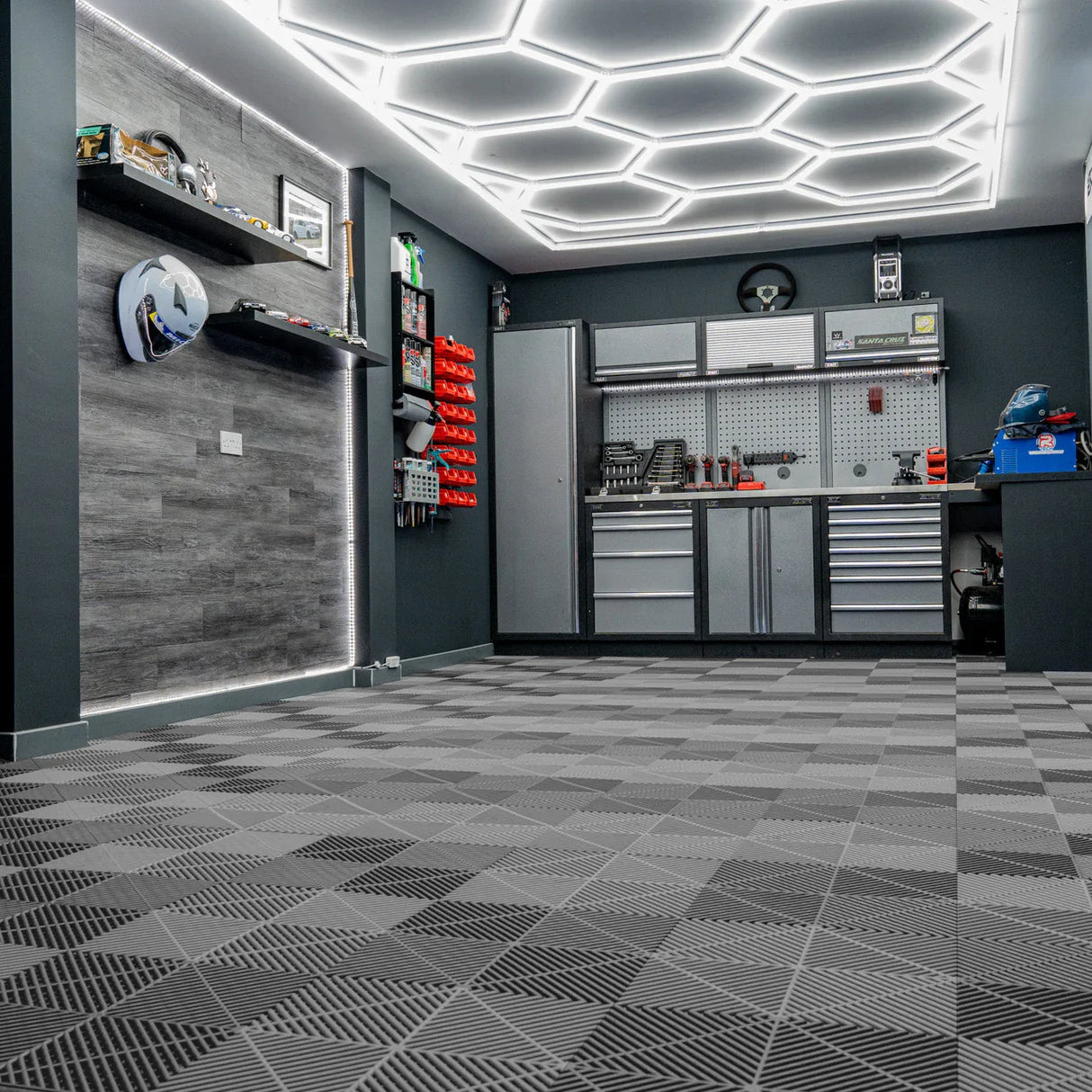 Vented grey garage floor tiles arranged in a stylish pattern, enhancing the modern garage with a sleek, textured finish