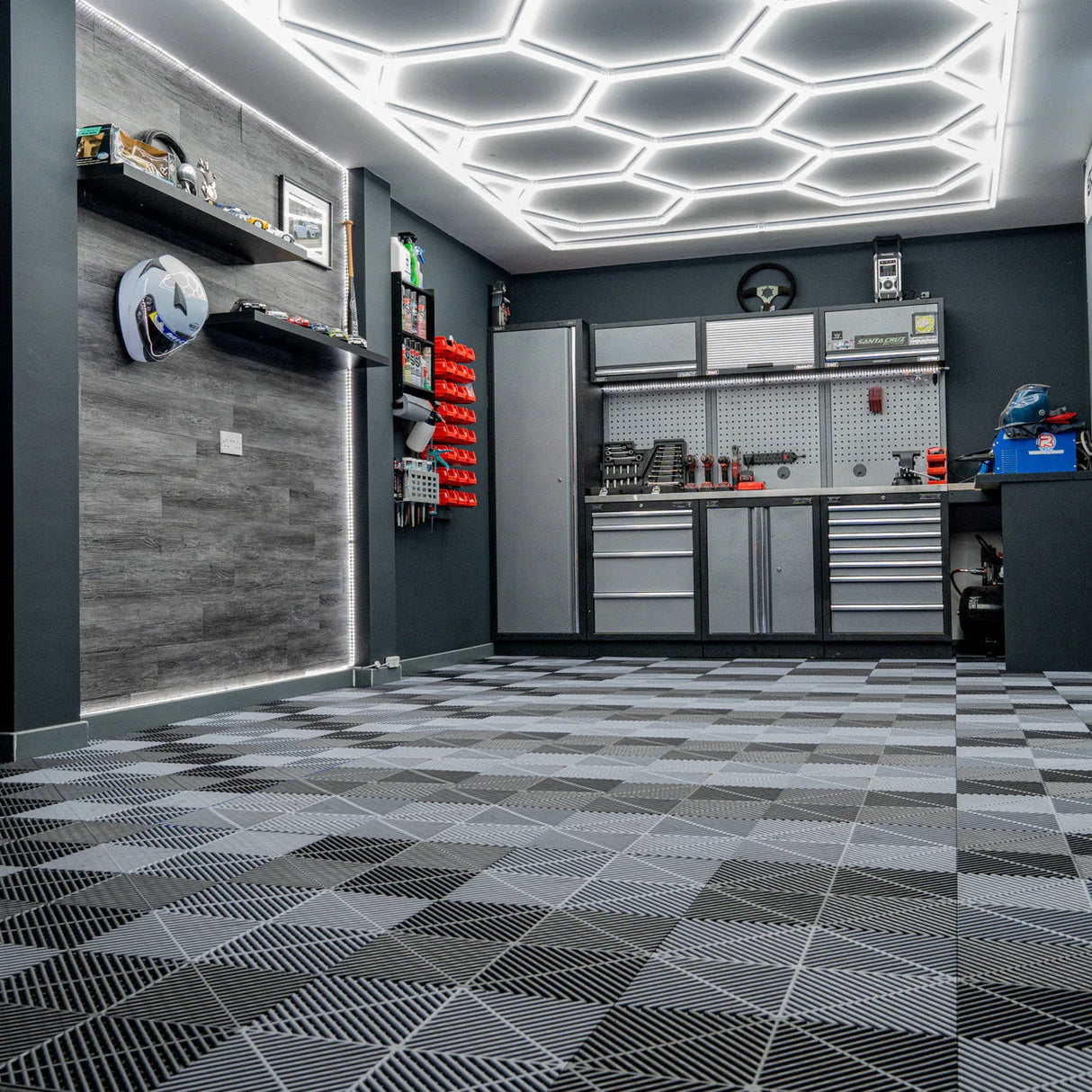 Vented garage floor tiles in black and grey, featuring a textured surface and interlocking edges, arranged in a stylish pattern
