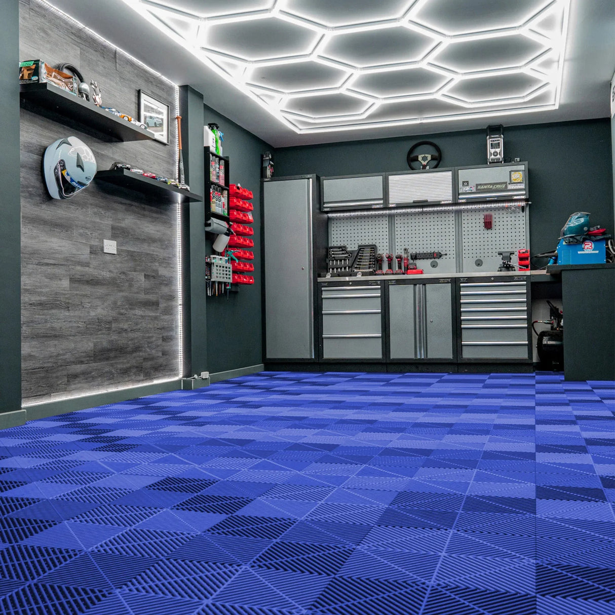 Hexagon LED light and blue vented garage floor tiles arranged in a geometric pattern, enhancing a modern garage space with sleek design