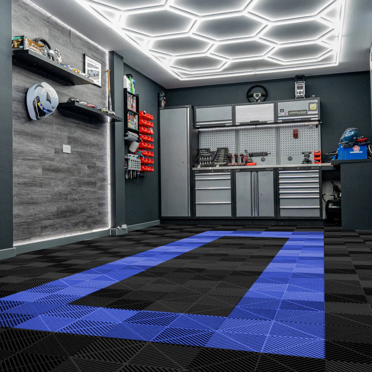 Hexagon LED light illuminates a garage with black and blue vented floor tiles, showcasing a sleek, modern design and textured surface