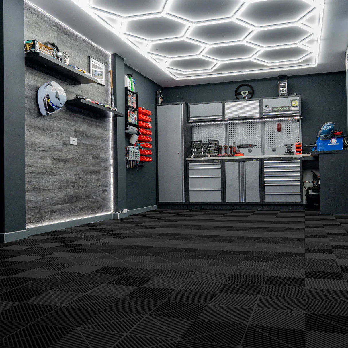 Hexagon LED lights illuminate a sleek garage with black vented floor tiles, featuring a modern design and textured surface