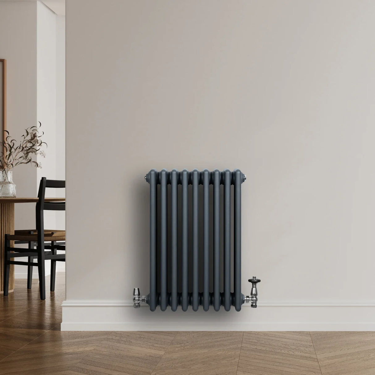 Traditional 4 column radiator in anthracite grey, featuring a sleek design with vertical fins, mounted on a light wall in a modern room